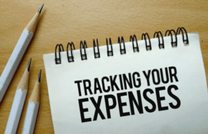 Notebook with text tracking your expenses